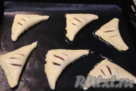 Смазать слойки взбитым желтком и поставить в разогретую духовку.