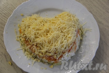 Поверх желтков разложить натёртый на мелкой тёрке сыр.