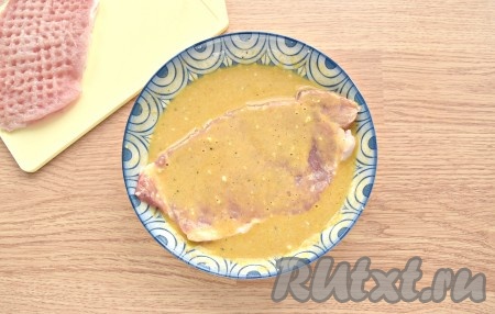 В чашу мультиварки вливаем растительное масло. Выбираем на дисплее программу «Жарка» (я пользуюсь мультиваркой Redmond, время устанавливается автоматически на 15 минут). Ждём, пока масло прогреется (обычно это 2-3 минуты). А теперь берём свиную отбивную и окунаем её полностью в приготовленный кляр. Также поступаем и со следующей отбивной.