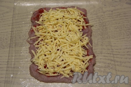 Сыр натереть на тёрке и выложить ровным слоем на куриное филе.