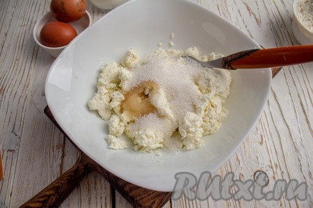 В подходящую миску выложите творог и добавьте сахар, перемешайте вилкой. Сахара можно добавлять больше или меньше, здесь регулируйте по своему вкусу. По этому рецепту оладьи получаются в меру сладкими. Для однородности теста творог можно предварительно пробить блендером или протереть через сито, но я этого не делала, так как мне нравится присутствие небольших комочков творога в оладьях.