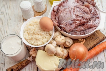 Подготовьте все необходимые ингредиенты для приготовления в духовке кальмаров, фаршированных рисом и грибами. Рис заранее отварите до полуготовности, для этого тщательно промойте крупу, затем поместите в кипящую воду и варите после закипания на среднем огне минут 10-12 (рисинки должны стать достаточно мягкими), затем лишнюю воду слейте и дайте рису остыть.