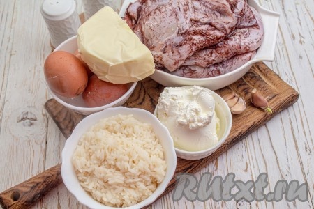 Подготовьте все необходимые ингредиенты для приготовления кальмаров, фаршированных рисом и яйцами. Рис заранее отварите до готовности, для этого выложите промытый рис в достаточно большое количество кипящей подсоленной воды и варите с момента закипания на умеренном огне минут 20 (до готовности), затем лишнюю воду слейте, рис промойте холодной водой и оставьте его на некоторое время, чтобы стекла лишняя жидкость. Для фарширования кальмаров потребуется 1 стакан варёного риса. Вкрутую сварите яйца (на отваривание с момента закипания воды потребуется минут 9-10), дайте им полностью остыть, затем очистите от скорлупы.