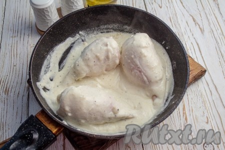 В соус выложите фаршированных кальмаров, полейте их сверху сметанным соусом, доведите соус до кипения. Затем тушите кальмаров под крышкой 5-7 минут на небольшом огне. В процессе приготовления можно перевернуть кальмаров один раз на другую сторону, поливая сверху сметанным соусом.