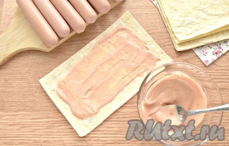 Майонез смешиваем с томатным кетчупом и получившимся соусом смазываем заготовки из лаваша, отступая от краёв по 1 см.