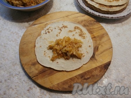 На каждый блин выложить по 1-2 столовых ложки начинки из капусты и фарша.