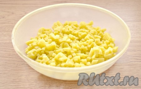 Очищаем картошку, ополаскиваем под холодной водой. Нарезаем картофель на мелкие кубики, перекладываем в достаточно объёмную миску.

