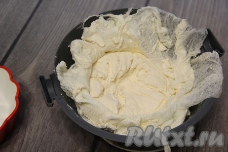 Аккуратно собрать свисающие кончики марли над сыром и связать в узел, поставить на сыр гнёт (например, накрыть сыр в марле тарелкой, а сверху поставить банку с водой) и отправить всю "конструкцию" в холодильник на 2 суток. По истечении двух суток достать форму с сыром из холодильника. Развернуть марлю, достать сыр.