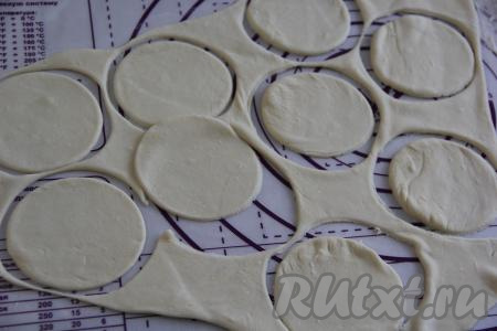 На слегка присыпанной мукой поверхности отдохнувшее тесто раскатать в тонкий пласт толщиной 2 мм и вырезать кружочки для вареников с помощью кольца или стакана. Я вырезала кольцом диаметром 8,5 сантиметров.