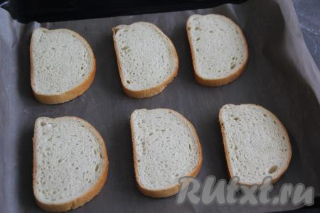 Противень застелить тефлоновым ковриком (или пергаментной бумагой), затем выложить кусочки батона. 
