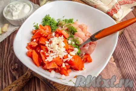 Два помидора среднего размера промойте, обсушите и нарежьте на небольшие кубики. Свежий укроп и чеснок нарежьте мелко. К куриному филе добавьте помидоры, чеснок и укроп.