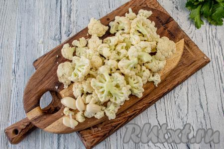 Цветную капусту промойте, обсушите и разделите на небольшие соцветия. Чеснок очистите от шелухи.