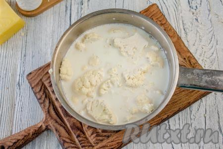 В подходящий ковш влейте молоко, посолите по вкусу и доведите до кипения. Опустите в кипящее молоко соцветия свежей (или замороженной) цветной капусты и после закипания варите на минимальном огне 10-15 минут (до мягкости капусты).