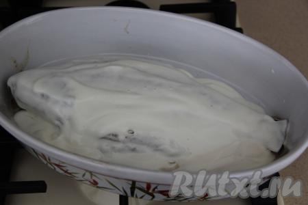 Затем достать форму с лещом, выложить сметану по всей поверхности рыбы. Поставить форму с рыбой обратно в духовку и запекать ещё 20 минут.&nbsp;