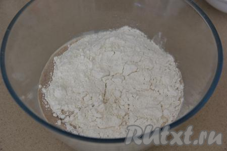 В миску с молочно-дрожжевой смесью добавить яйцо, всыпать соль и начать частями подсыпать муку, замешивая тесто для шанег венчиком.