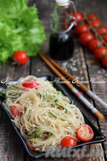 Подать салат из фунчозы с огурцами и помидорами к столу, посыпав, по желанию, кунжутом или рубленной зеленью.