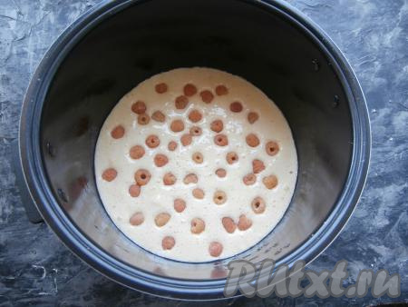 Малину (или другие ягоды) вымыть, обсушить. Замороженные ягоды, если на них нет большого количества льда, можно не размораживать. Поверх пергамента вылить тесто и сверху разместить ягоды, крышку мультиварки закрыть.