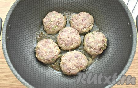 На сковороде разогреваем масло, огонь делаем средним. Выкладываем в горячее масло заготовки котлет, обжариваем с одной стороны 5 минут. Затем котлеты переворачиваем, сковороду накрываем крышкой и продолжаем обжаривать ещё 4 минуты.