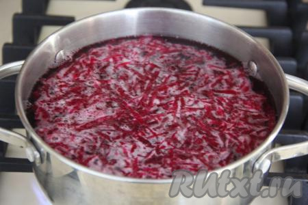 В кастрюлю влить 1,5 литра воды и поставить на огонь. Свеклу почистить и натереть на крупной тёрке. Свекольную ботву помыть под водой, испорченные листочки удалить, затем нарезать на полоски шириной, примерно, 1,5 сантиметра. После того как вода в кастрюле закипит, выложить в кипящую воду натёртую свеклу и варить с момента закипания 5 минут на умеренном огне.&nbsp;