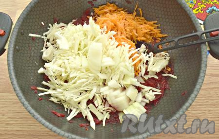 Через 20 минут добавляем в свекольно-томатную массу достаточно тонко нарезанную капусту, нарезанный на небольшие кусочки лук и натёртую на крупной тёрке морковку, перемешиваем, тушим на умеренном огне минут 10, помешивая.