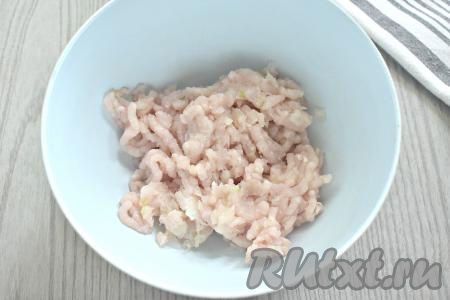 Кусочки куриного мяса и лука прокручиваем через мясорубку в глубокую миску.