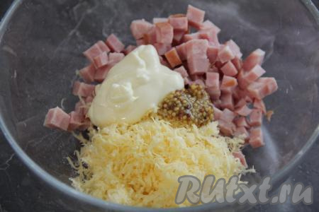 70 грамм сыра натереть на тёрке. Ветчину нарезать на кубики. Выложить ветчину с сыром в отдельную миску, добавить сметану и горчицу.