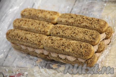 На следующий день тирамису переложить на плоскую тарелку (или подставку) и освободить от плёнки.