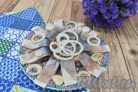 Через сутки достаём рыбку, аккуратно снимаем кожу, нарезаем на кусочки и подаём к столу.&nbsp; Я подала вместе с колечками репчатого лука, очень аппетитно выглядит. Селёдка получается малосольной, очень нежной и вкусной, а готовится в домашних условиях всего за 24 часа.