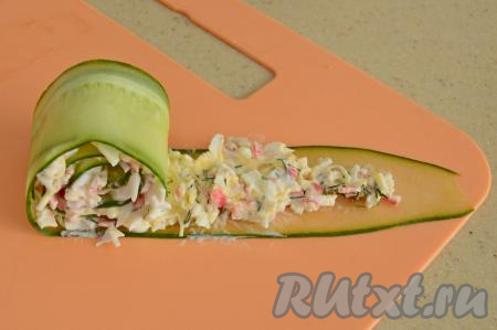 Начиная с края с начинкой, свернуть полоску в плотный рулетик.