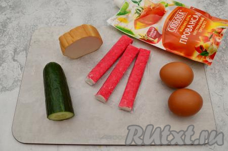 Подготовить продукты для приготовления салата с колбасным сыром и крабовыми палочками. Яйца заранее отварить в течение 10 минут после закипания воды, после этого их нужно остудить и очистить. Крабовые палочки полностью разморозить, убрать с них плёнку. Огурец вымыть.