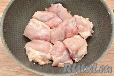 Подготовленное куриные бёдра перекладываем в сковороду с высокими бортиками.