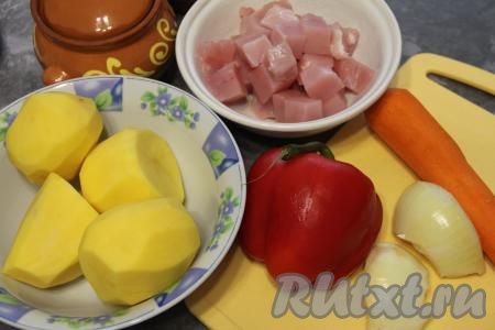 Подготовить продукты для приготовления жаркого из индейки с картошкой в горшочке. Картошку, морковь и лук почистить. Очищенный картофель залить водой, чтобы он не потемнел. Из болгарского перца удалить семена с плодоножкой. Филе индейки нарезать на средние кусочки.