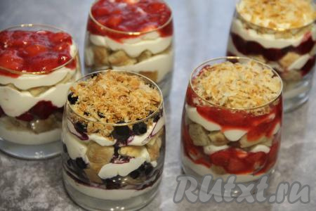 Для формирования десерта взять стаканчики (я взяла 5 штук) и начать выкладывать слоями: часть крема, часть квадратиков из слоёного теста, часть ягодного конфи (я клубничное конфи разложила по 3 стаканчикам, а вишнёвое конфи - по 2 стаканчикам) и часть ягод (у меня - малина и черника). Повторять слои, пока стаканы не будут заполнены. Количество слоёв зависит от высоты стаканчиков. Пару квадратиков из слоёного теста раскрошить и украсить верх десерта. Готовый ягодный трайфл поставить в холодильник на пару часов.