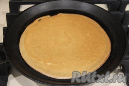 Выпекать блин с двух сторон до золотистого цвета на среднем огне. Затем тонкий блинчик переложить на плоскую тарелку. Периодически перемешивая блинное тесто, постепенно пожарить все французские блины, складывая их горочкой на тарелку.