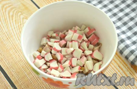 Нарезаем крабовые палочки на маленькие кубики и добавляем к копчёной курице.