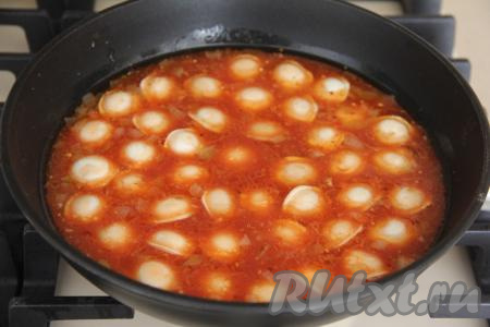 Как только томатный соус закипит, выложить пельмени в сковороду. Пельмени должны лежать в один слой и быть практически полностью покрыты соусом. Если пельмени замороженные, их не следует предварительно размораживать. Накрыть сковороду крышкой и тушить пельмени на среднем огне минут 12 (за это время 1-2 раза их можно аккуратно перемешать).