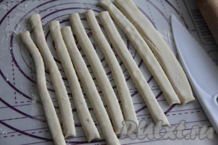 Нарезать тесто на полоски шириной приблизительно 1 сантиметр.