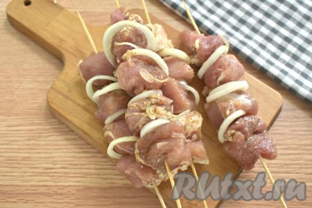 Нанизываем замаринованные кусочки свинины на деревянные шпажки, чередуя мясо с колечками маринованного лука.