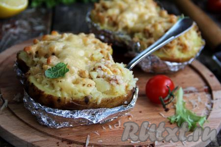 Вкусный, аппетитный запечённый картофель, фаршированный фаршем, достать из духовки и подать к столу в горячем виде, можно даже не снимая фольгу. 