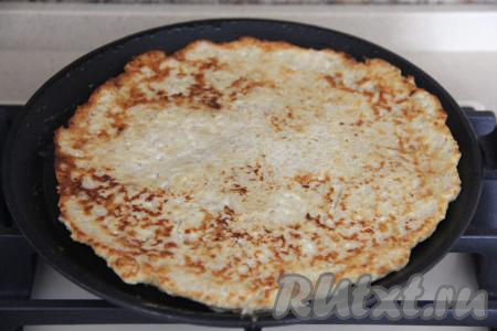 Жарить овсяноблин с творогом и бананом на среднем огне с двух сторон до золотистого цвета (ориентировочно по 3-4 минуты с каждой стороны).