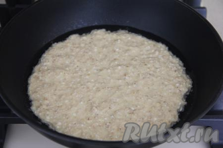 Сковороду (я жарила на сковороде диаметром 20 сантиметров) смазать маслом и хорошо разогреть. Выложить на сковороду овсяную массу. Равномерно распределить массу по дну сковороды. 