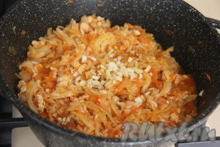 Перемешать и тушить под крышкой с момента закипания на небольшом огне 25 минут (капуста должна стать мягкой). Чеснок мелко нарезать и добавить в конце тушения, перемешать.