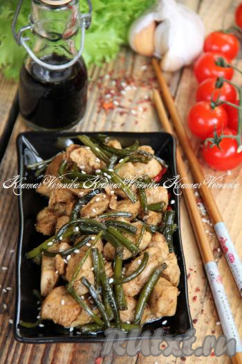 Переложить нежные, мягкие кусочки курицы с ароматными чесночными стрелками со сковороды на тарелки и подать с гарниром к столу. Я перед подачей посыпала это вкусное блюдо кунжутом.