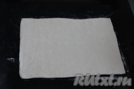 У меня тесто было в двух пластах. Слегка раскатать первый пласт теста на слегка присыпанной мукой поверхности. Переложить раскатанный пласт на противень, застеленный ковриком (или бумагой) для выпечки.