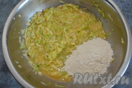 В получившуюся кабачково-сырную массу всыпать 100 грамм муки, перемешать. 