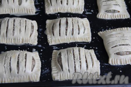 По желанию, присыпать пирожки кунжутом, а затем поставить в духовку, заранее прогревшуюся до 180 градусов.