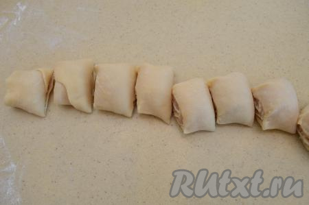 Острым ножом разрезать рулет на рулетики толщиной 3-4 сантиметра - это и будут наши ленивые пельмени. Из одной половины теста у меня вышло 12 заготовок ленивых пельменей.