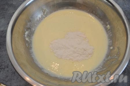 Добавить в яично-творожную массу половину муки, перемешать. Затем небольшими порциями подсыпая муку, добиться консистенции теста, которая бы напоминала сметану средней густоты.