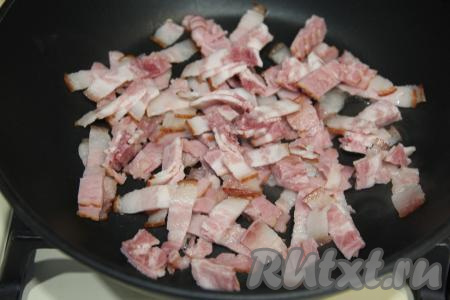 Сковороду разогреть. Бекон нарезать на полоски (или квадратики) и добавить в сковороду.