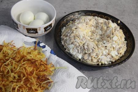 На плоскую тарелку выложить салат в виде гнезда с бортиками.